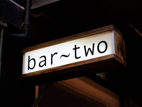 the bright lit signage of Bar Two in Launceston