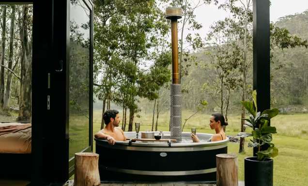 a couple relaxing in the outdoor tub at Billy’s Hideaway, Hunter valley