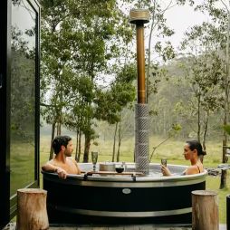 a couple relaxing in the outdoor tub at Billy’s Hideaway, Hunter valley