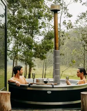 a couple relaxing in the outdoor tub at Billy’s Hideaway, Hunter valley