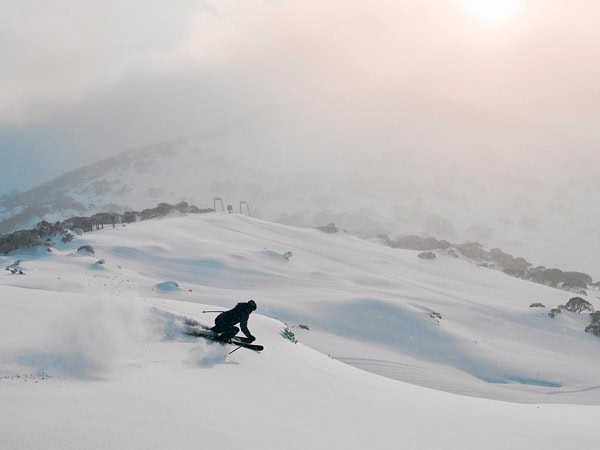 a woman skiing at Charlotte Pass Ski Resort