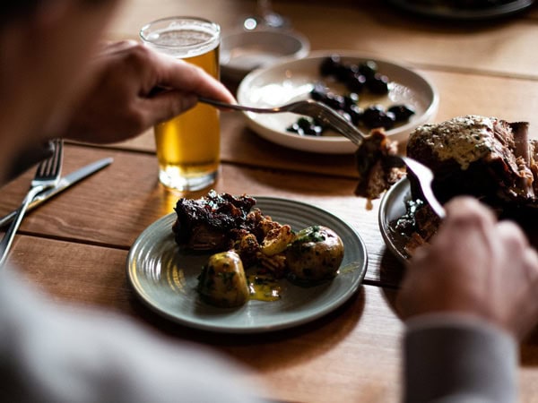 a person enjoying hearty meals at Deep South Brewing Co.