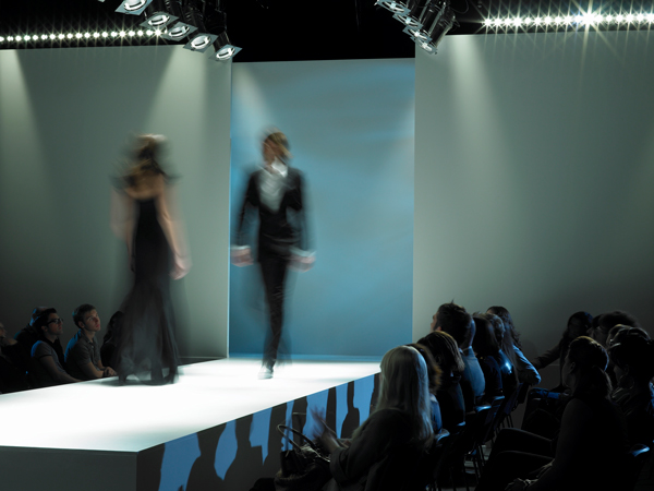 General image of two models walking the runway at a fashion show