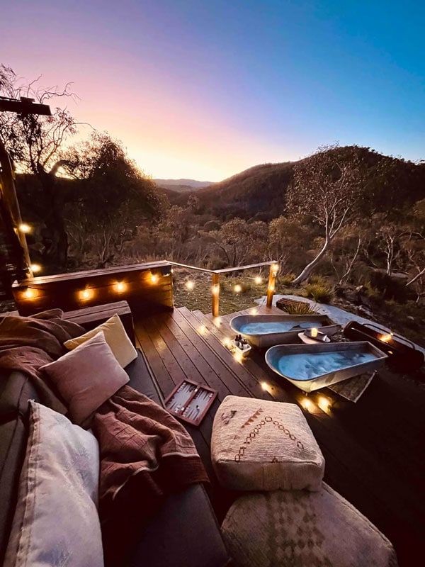 a verandah with outdoor tubs at Glamping in the Snowy Mountains, Jindabyne