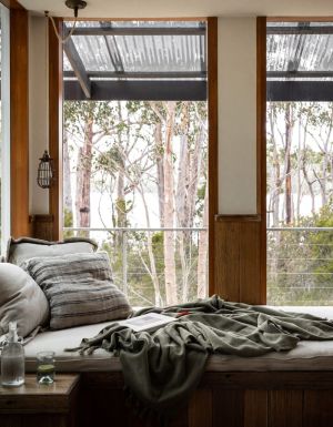 a bed with scenic bush views at The Voyager, Huon Valley
