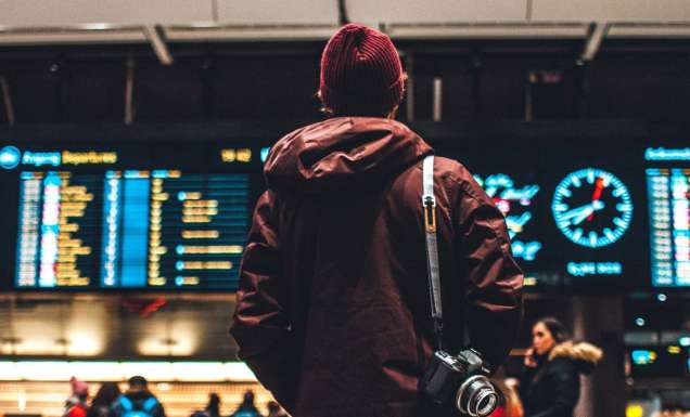 Person looking at flight schedule in airport