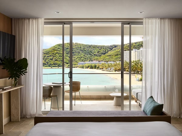 A sliding window looking out the balcony with Coral Sea views.