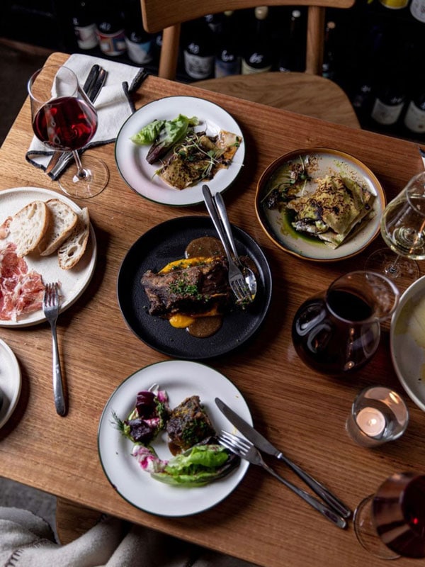 a table-top view of meals and wine at Havilah Wine Bar