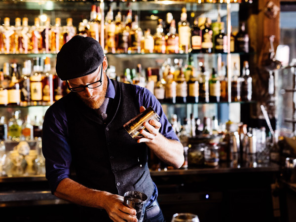 a bartender preparing a drink at IXL long bar, The Henry Jones Art Hotel
