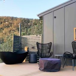 an outdoor deck with a tub at Rosebook Eco Tiny Home, Hunter Valley