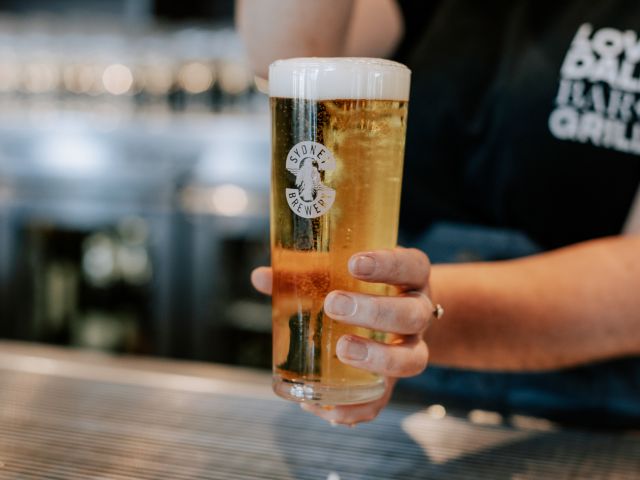 a hand holding a glass of beer at Sydney Brewery Hunter Valley