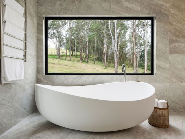 a bathtub with nature views at Cedars Mount View, Hunter Valley