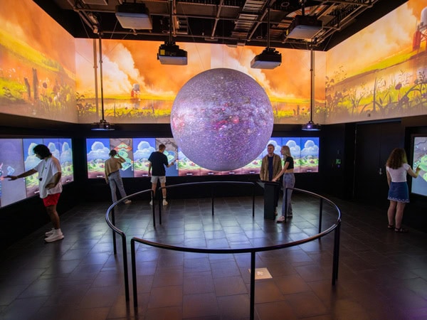 people exploring a planetarium inside the MOD Museum of Discovery