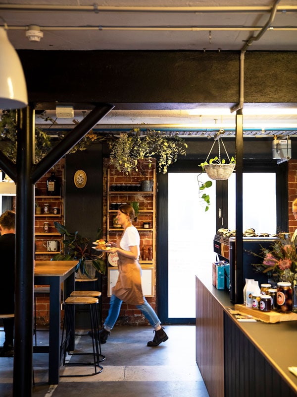 a staff walking inside the My Grandma Ben cafe, Adelaide 