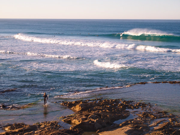 Surfer at beach in Robe, South Australia