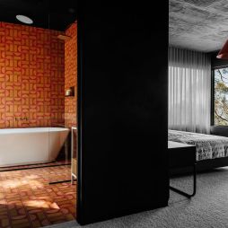 Interior view of the bedroom and bathroom at Slow Beam in Hobart