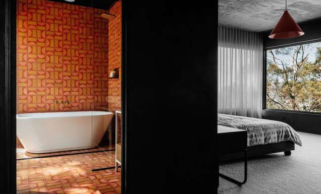 Interior view of the bedroom and bathroom at Slow Beam in Hobart