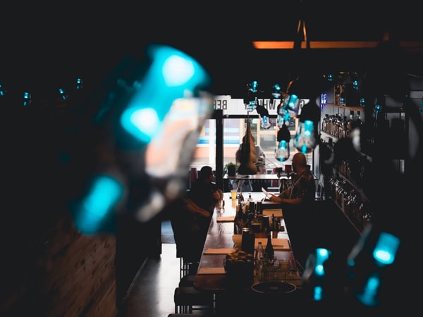a bar interior with dark lighting at The Barrel Collective