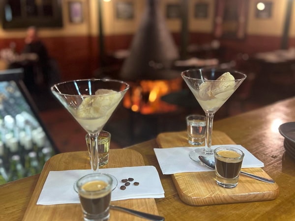 cocktails glasses by the fireplace at Three Steps on George pub in Launceston