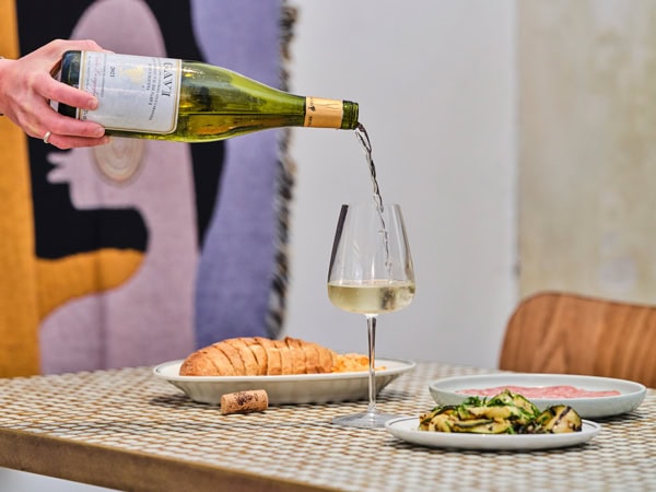 pouring a drink into a glass at Vin Populi