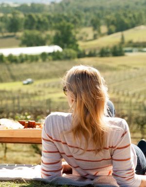 a couple enjoying a romantic date among the vines in the Hunter Valley