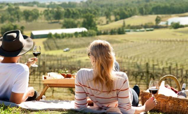 a couple enjoying a romantic date among the vines in the Hunter Valley