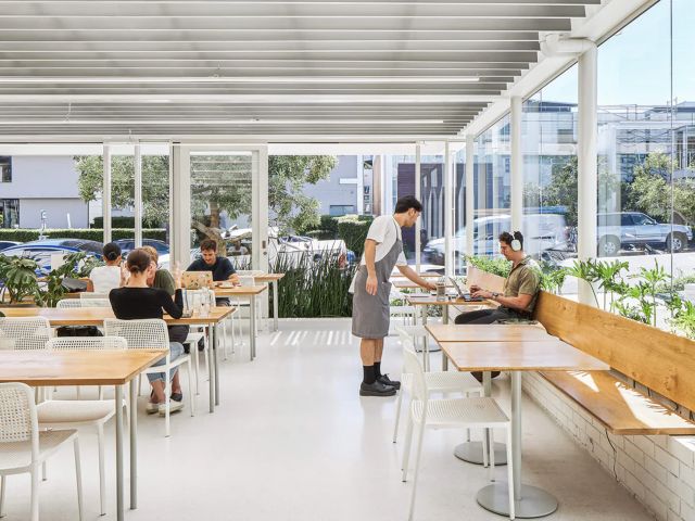a waiter serving a diner at Industry Beans Newstead