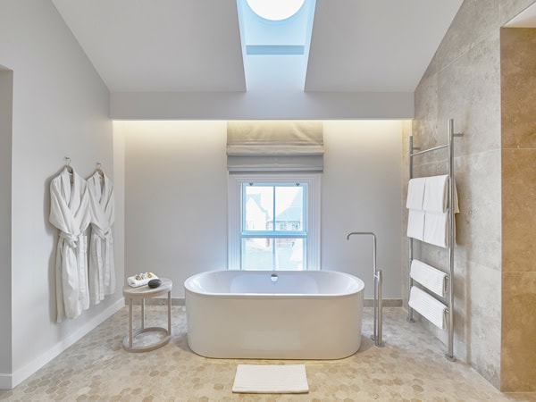 a modern bathroom with a bathtub at COMO The Treasury, Perth