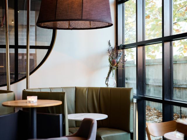 a booth at Romanée Wine Bar