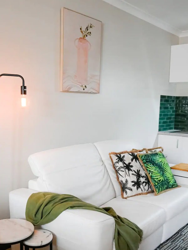 a white sofa inside the cosy city edge studio Airbnb in Perth