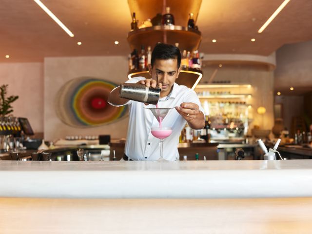 a bartender preparing a drink at Hurricane's Grill & Bar Cronulla Beach
