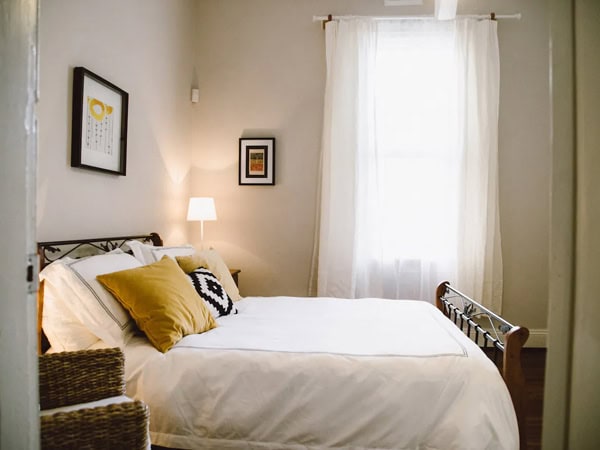 the bed at Cute Northbridge house Airbnb in Perth