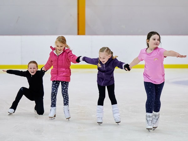 kids holding hands while ice skating at Erina Ice Arena
