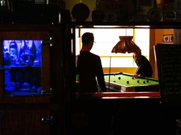 friends playing pool at Grace Emily Hotel