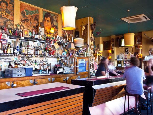 friends sitting at the bar counter of Grace Emily Hotel
