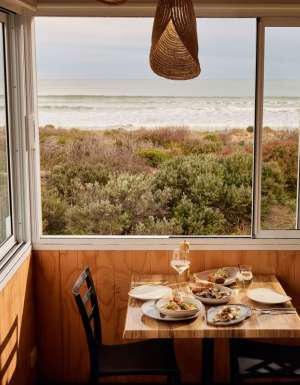 a dining setup at Kuti Shack overlooking Goolwa Beach