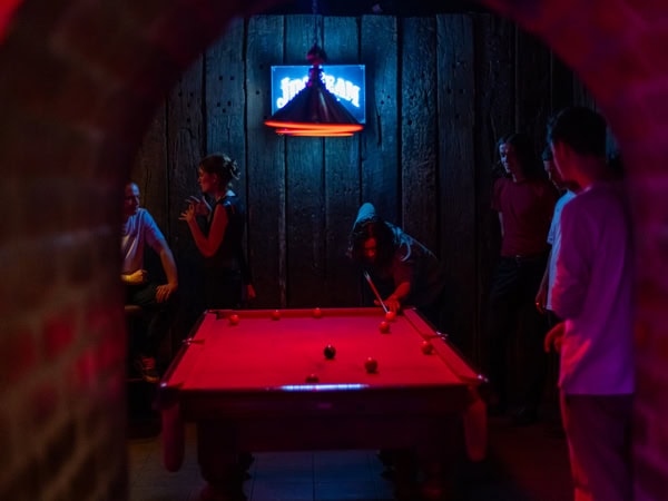 friends playing pool at the dimly lit bar in Memphis Slim’s House Of Blues, Adelaide