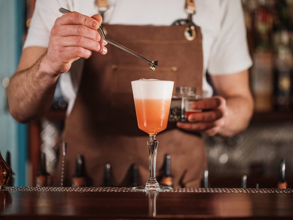 a close-up shot of a bartender preparing a drink at Nola, Adelaide