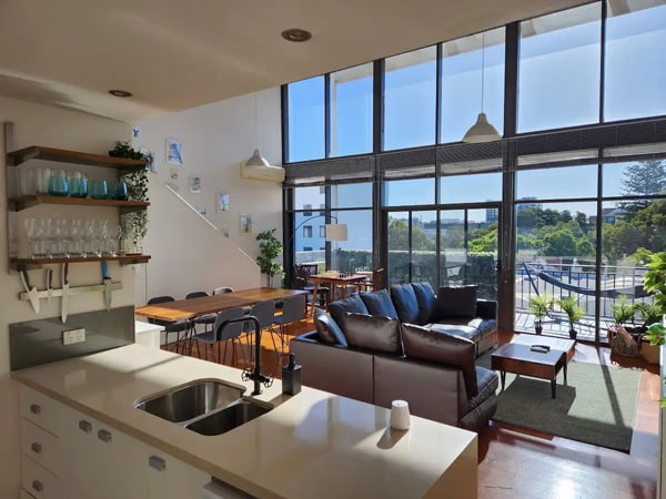 a spacious Airbnb with high-beamed ceilings, floor-to-ceiling windows in Perth