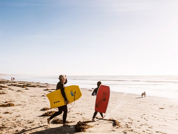 surfers heading out to the beach in Port Fairy