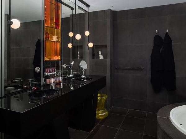 a dimly lit bathroom at QT Sydney