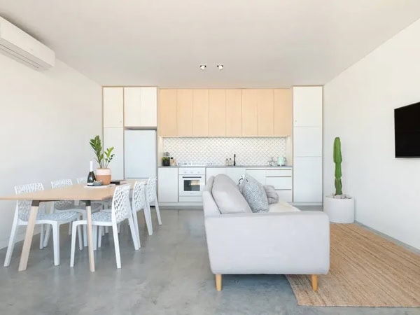 the white-washed living space at The Cottesloe cabin Airbnb in Perth