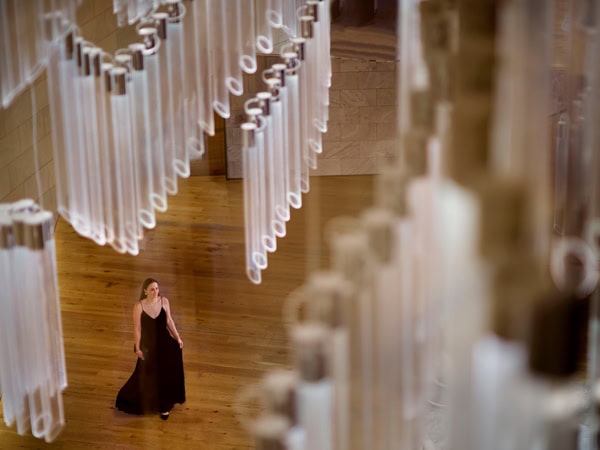 a woman dressed in black under a custom chandelier at the lobby of Ritz Carlton Perth 