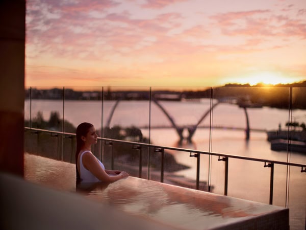 a woman soaking in the infinity pool at Ritz Carlton Perth