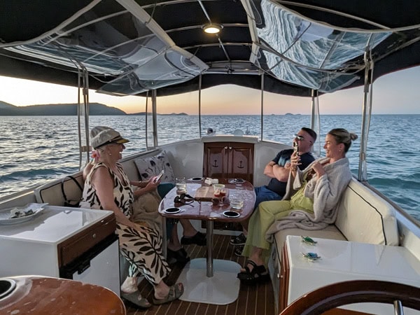 guests aboard Whisper Cruises at sunset