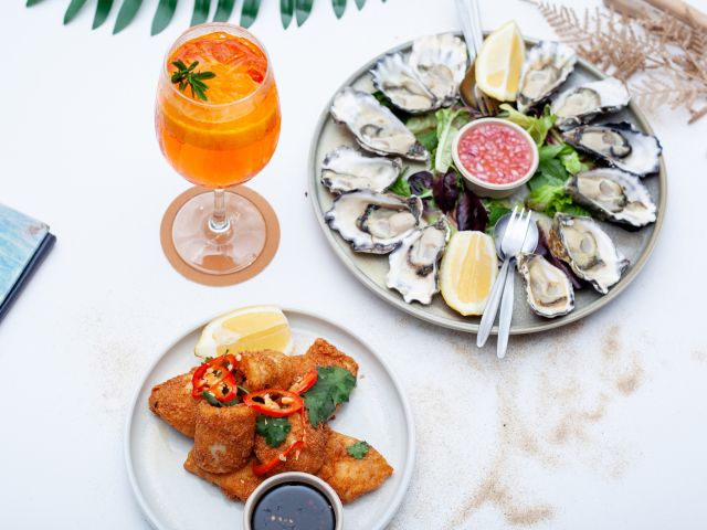 a platter of oysters with a cocktail drink at The Entrance Social Club, Central Coast