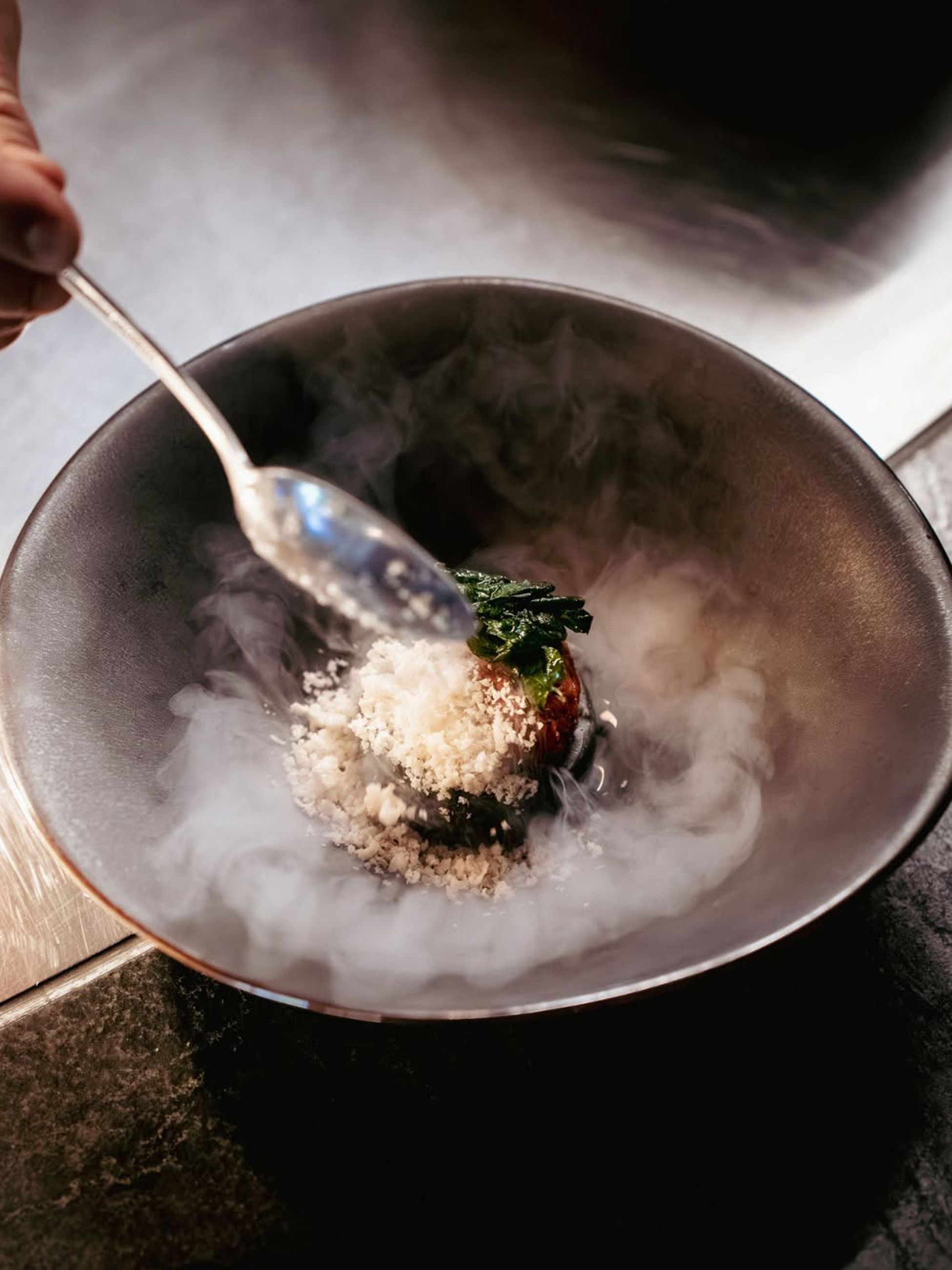 a smoking fine-dining dish at Aurora at ILA