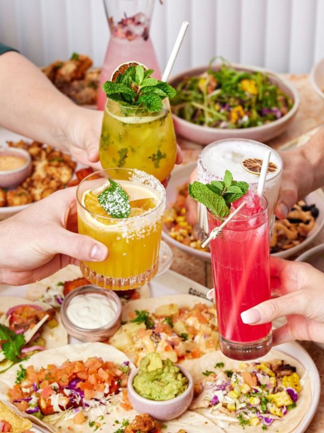clinking cocktail glasses over brunch at Comuna Cantina, Brisbane
