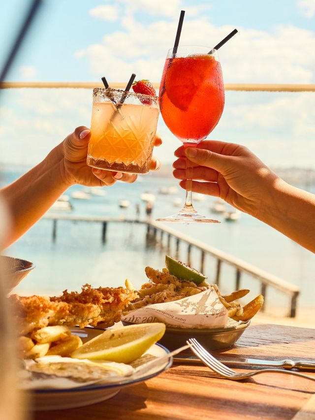 raising cocktail glasses over seafood lunch at Summer Salt Cronulla