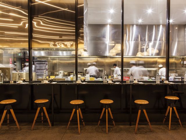 an open kitchen and dining counter at CBD Dumpling House